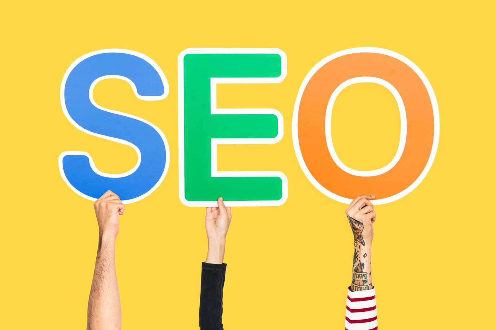 hands holding up colorful letters forming abbreviation seo 1 scaled