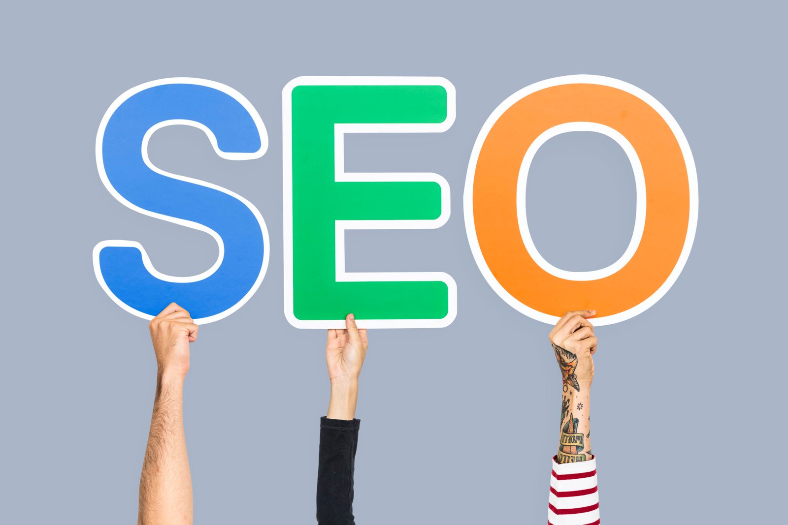 hands holding up colorful letters forming abbreviation seo scaled